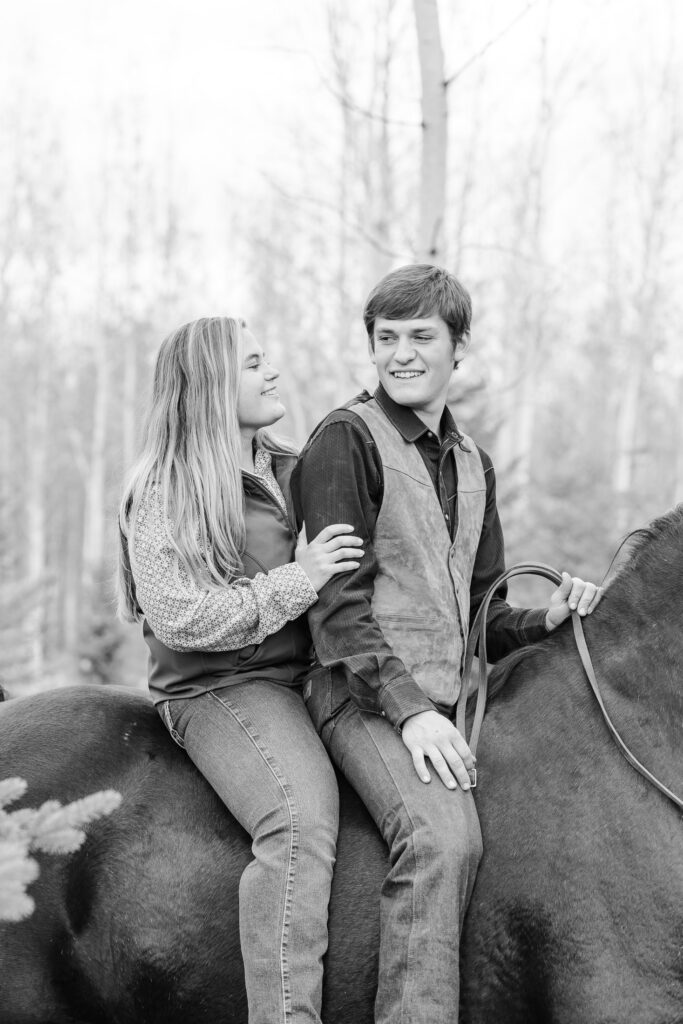 young couple riding a horse