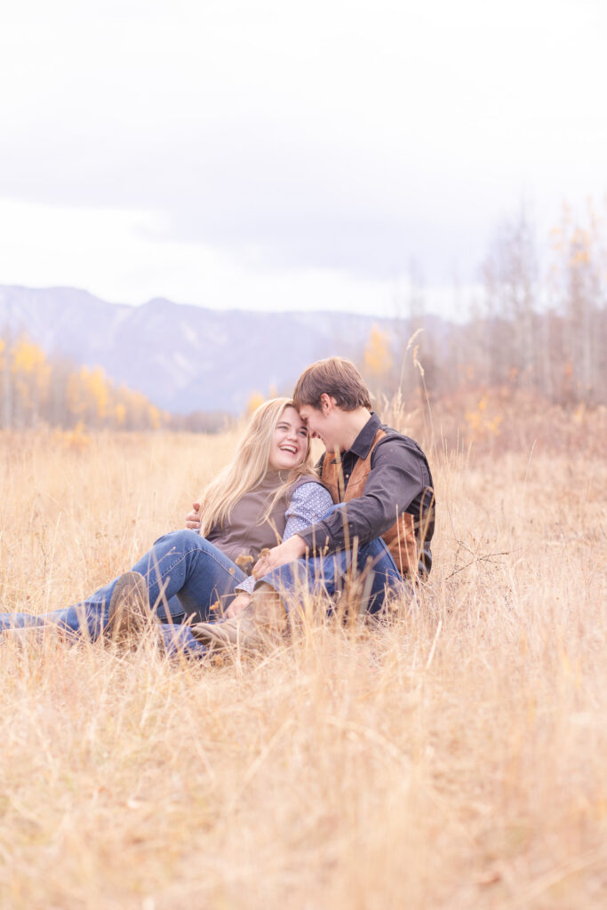 couple sitting on ground lauging